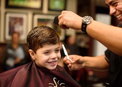 V's barber giving a kids hair cut