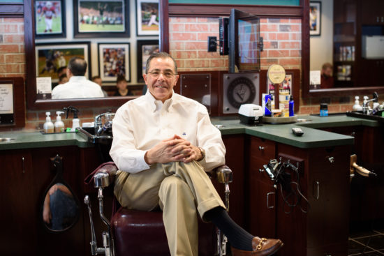 Owner of V's, Jim Valenzuela, sitting in a barber chair
