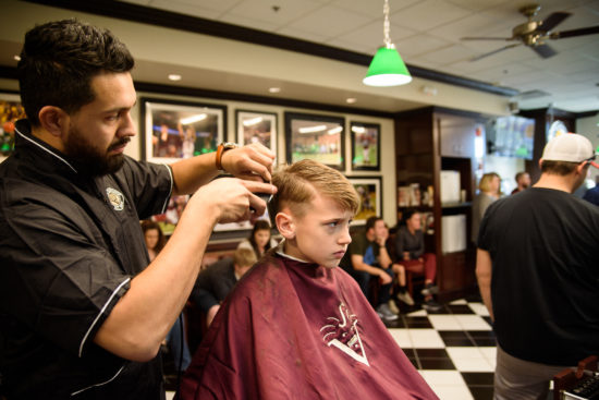 barber giving a kids hair cut