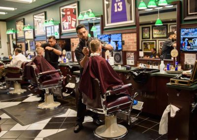 interior of V's Barbershop barbers giving haircuts