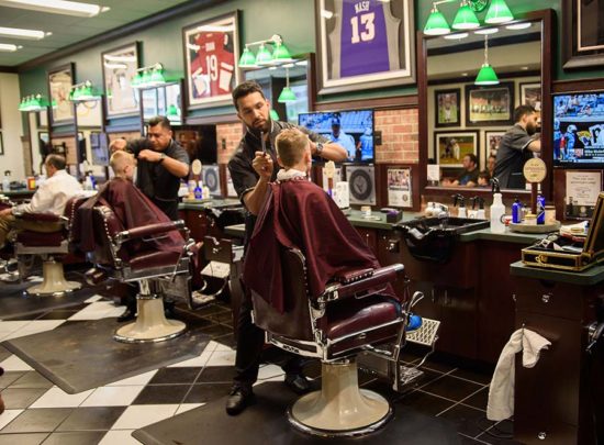 interior of V's Barbershop barbers giving haircuts