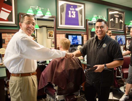 barber and owner of V's Barbershop, Jim Valenzuela, shaking hands