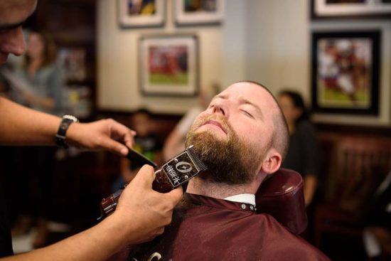 patron getting a beard trim