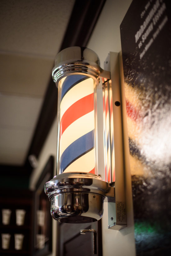 Barber Pole lit up inside of barbershop