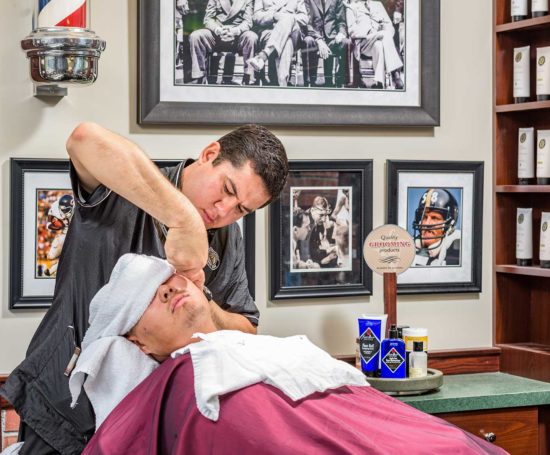 Barber giving a patron a straight-razor shave