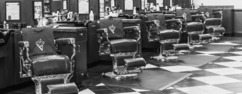 interior image of barbershop with five empty barber chairs