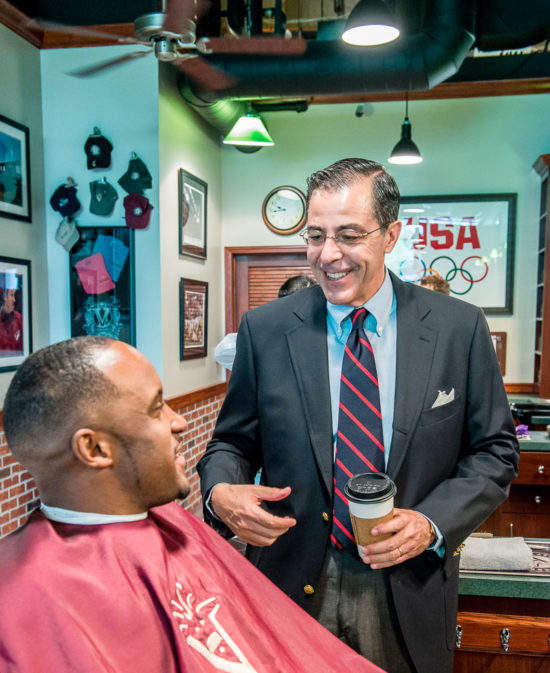 Jim Valenzuela greeting a patron at V's Barbershop