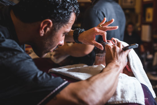 barber giving patron a straight-razor shave